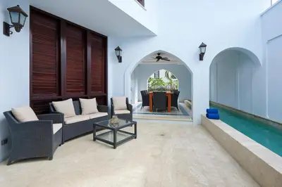 a living room with a couch and a table and a pool at Casa Cazenovia - 3BR home, astonishing rooftop terrace in Las Catalinas in Playa Danta