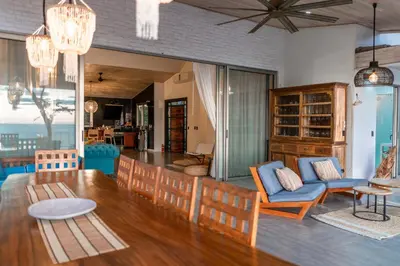 a dining room and living room with a table and chairs at Grand Oceanview Villas - Casa Aria and Casa Magnifique in Santa Teresa Beach