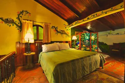 a bedroom with a bed in a room at Hotel La Mansion Inn Arenal in Nuevo Arenal