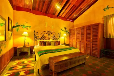 a bedroom with a large bed in a room at Hotel La Mansion Inn Arenal in Nuevo Arenal