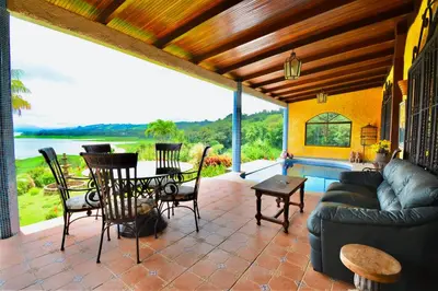 a living room with a couch and a table at Hotel La Mansion Inn Arenal in Nuevo Arenal