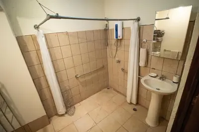a bathroom with a shower and a sink at Anona Guesthouse in Playa Hermosa