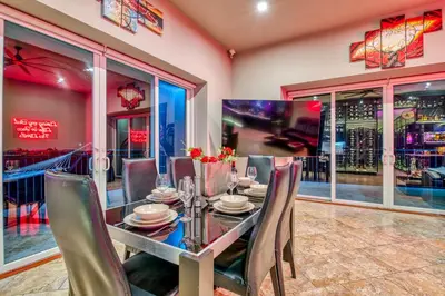 a dining room with a table and chairs and windows at SecretJaco - Luxury Beach Front Penthouse with Pool & Jacuzzi in Jacó