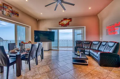 a living room with a couch and a table at SecretJaco - Luxury Beach Front Penthouse with Pool & Jacuzzi in Jacó