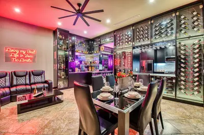 a wine tasting room with a table and chairs at SecretJaco - Luxury Beach Front Penthouse with Pool & Jacuzzi in Jacó