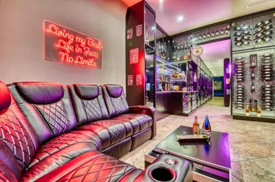 a bar with a leather couch and a table at SecretJaco - Luxury Beach Front Penthouse with Pool & Jacuzzi in Jacó