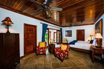 a bedroom with a bed and a ceiling fan at Casa Arrecife - 5bdr Beachfront Villa - Ethereal sunsets in Tamarindo