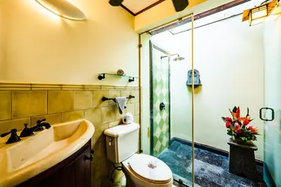 a bathroom with a tub and a toilet and a shower at Casa Arrecife - 5bdr Beachfront Villa - Ethereal sunsets in Tamarindo