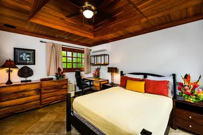 a bedroom with a bed and a wooden ceiling at Casa Arrecife - 5bdr Beachfront Villa - Ethereal sunsets in Tamarindo
