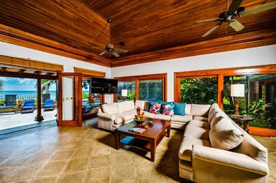 a living room with a couch and a table at Casa Arrecife - 5bdr Beachfront Villa - Ethereal sunsets in Tamarindo