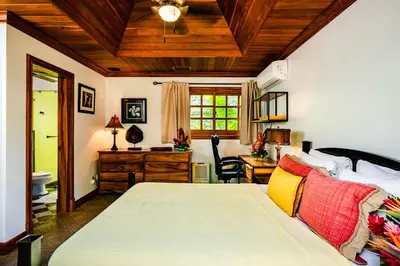 a bedroom with a bed and a desk in a room at Casa Arrecife - 5bdr Beachfront Villa - Ethereal sunsets in Tamarindo