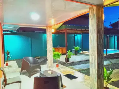 a patio with chairs and a swimming pool at Arenal Palacios in Fortuna