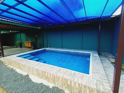 a large swimming pool with a blue ceiling at Arenal Palacios in Fortuna
