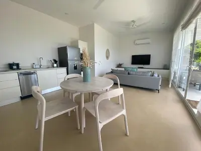 a kitchen and living room with a table and chairs at CASA AYLA B - charming 2BR ocean view condo in Flamingo in Playa Flamingo
