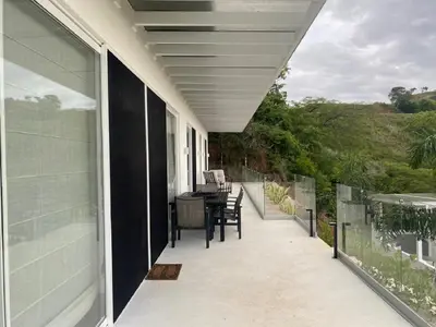 a balcony of a house with a table and chairs at CASA AYLA B - charming 2BR ocean view condo in Flamingo in Playa Flamingo