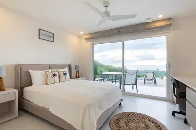 a bedroom with a bed and a view of the ocean at AYLA C - new, cozy Ocean view Studio in Flamingo in Playa Flamingo