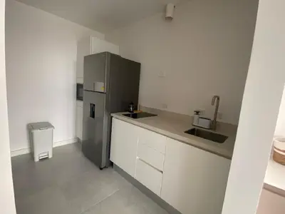 a kitchen with a refrigerator and a sink at AYLA C - new, cozy Ocean view Studio in Flamingo in Playa Flamingo