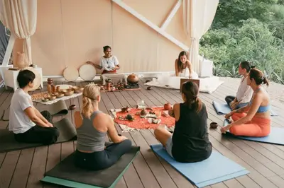 a group of people sitting on the floor in a yoga class at AYLA D - lovely Ocean view Studio in Flamingo in Playa Flamingo