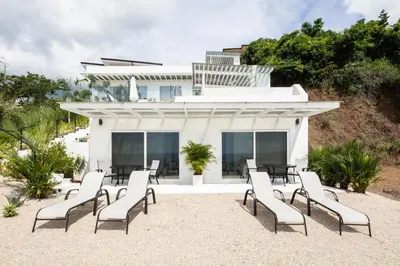 a group of chairs and tables in front of a building at AYLA D - lovely Ocean view Studio in Flamingo in Playa Flamingo