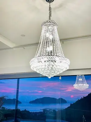 a large chandelier in a room with a large window at Casa Mar CR in Herradura
