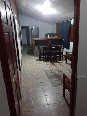 a hallway with a table and chairs in a room at Casa Chazu in Quepos