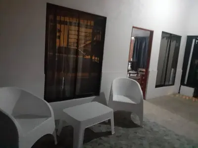 a room with chairs and a table and a mirror at Casa Chazu in Quepos
