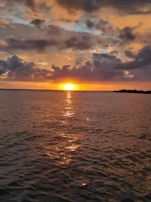 a sunset over a large body of water at Casa Chazu in Quepos