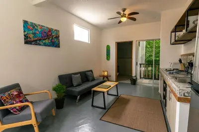 a living room with a couch and a table at Casa MONO in Santa Teresa Beach