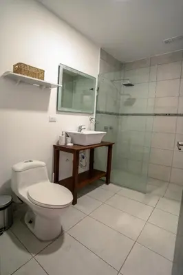 a bathroom with a toilet and a sink and a shower at Casa MONO in Santa Teresa Beach