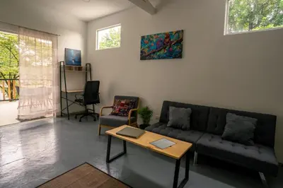 a living room with a couch and a table at Casa MONO in Santa Teresa Beach