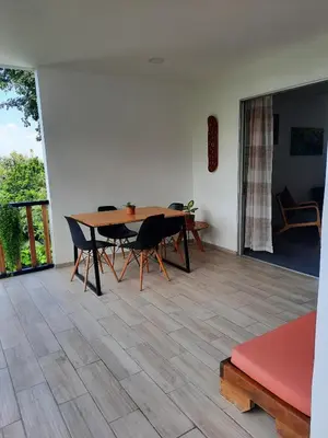 a dining room with a wooden table and chairs at Casa MONO in Santa Teresa Beach