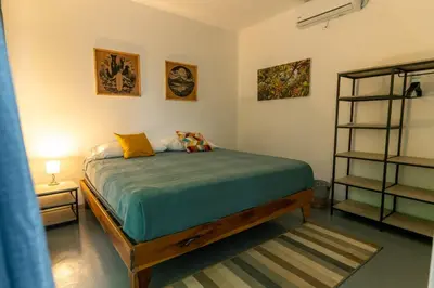 a bedroom with a bed in a room at Casa MONO in Santa Teresa Beach