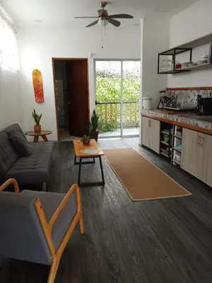 a living room with a couch and a table at Casa CIELO in Santa Teresa Beach