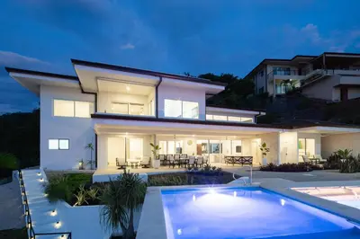 a house with a swimming pool in front of it at CASA AYLA A - stunning 5BR Ocean view house & infinity pool in Flamingo in Playa Flamingo