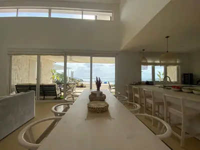 a kitchen with a long white table and chairs at CASA AYLA A - stunning 5BR Ocean view house & infinity pool in Flamingo in Playa Flamingo