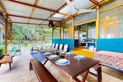 a dining room with a long table and chairs at Casa Beluga in Uvita