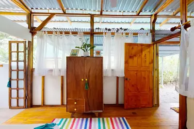 a room with two wooden doors and a rug at Casa Beluga in Uvita