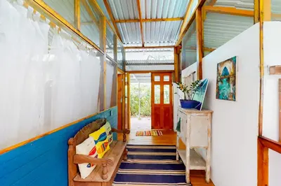 a hallway of a house with a blue and white wall at Casa Beluga in Uvita