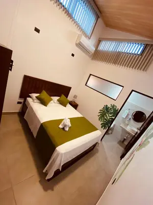 a bedroom with a large bed in a room at Casa Macaw in Fortuna