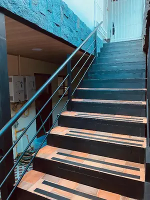 a set of stairs in a building with blue tiles at Casa Macaw in Fortuna