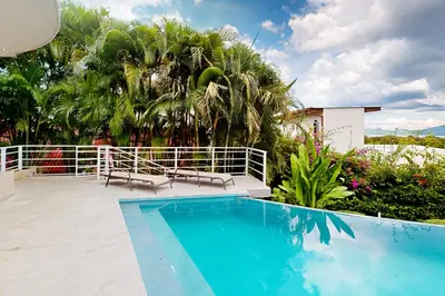 a swimming pool on top of a house at Casa Nalifos in Playa Flamingo