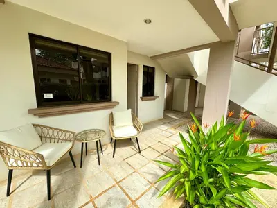 a patio with two chairs and a table at Coco Boho Beach Condo in Coco