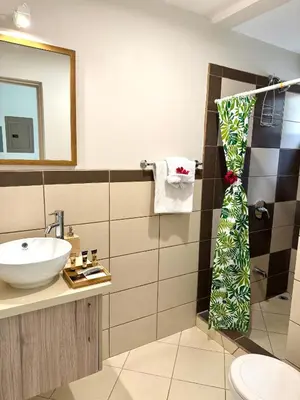 a bathroom with a sink and a mirror at Coco Boho Beach Condo in Coco