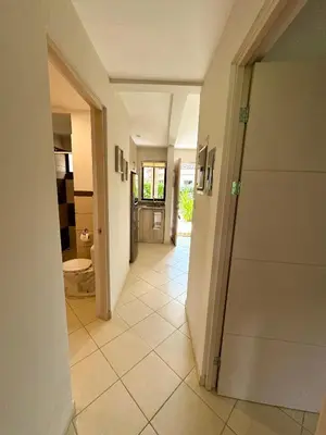 a hallway of a house with a tile floor at Coco Boho Beach Condo in Coco