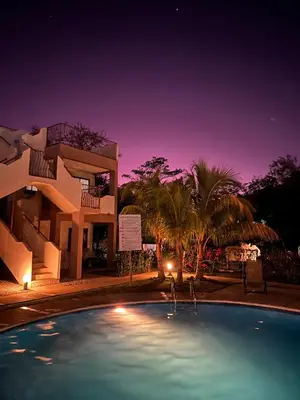 a large swimming pool in front of a building at Coco Boho Beach Condo in Coco