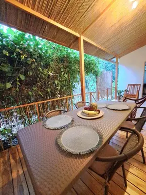 a table with plates on it on a porch at Colibrí Villa, 800 m from Beach in Uvita