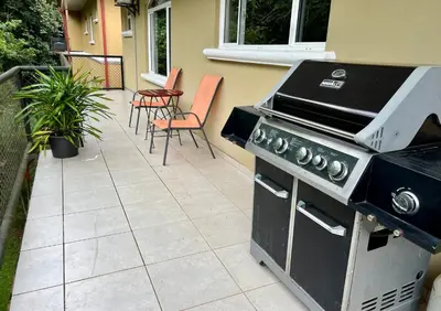 a grill on a patio with chairs and a table at Spacious Penthouse with pool & Jungle Views in La Mona