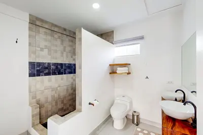 a bathroom with a toilet and a sink at Villa Verde I - 3 in Tamarindo