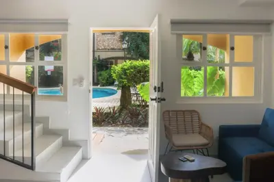 a living room with a door leading to a pool at Villa Verde I - 3 in Tamarindo