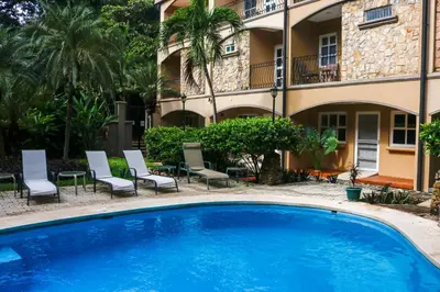 a large blue swimming pool in front of a building at Villa Verde I - 3 in Tamarindo